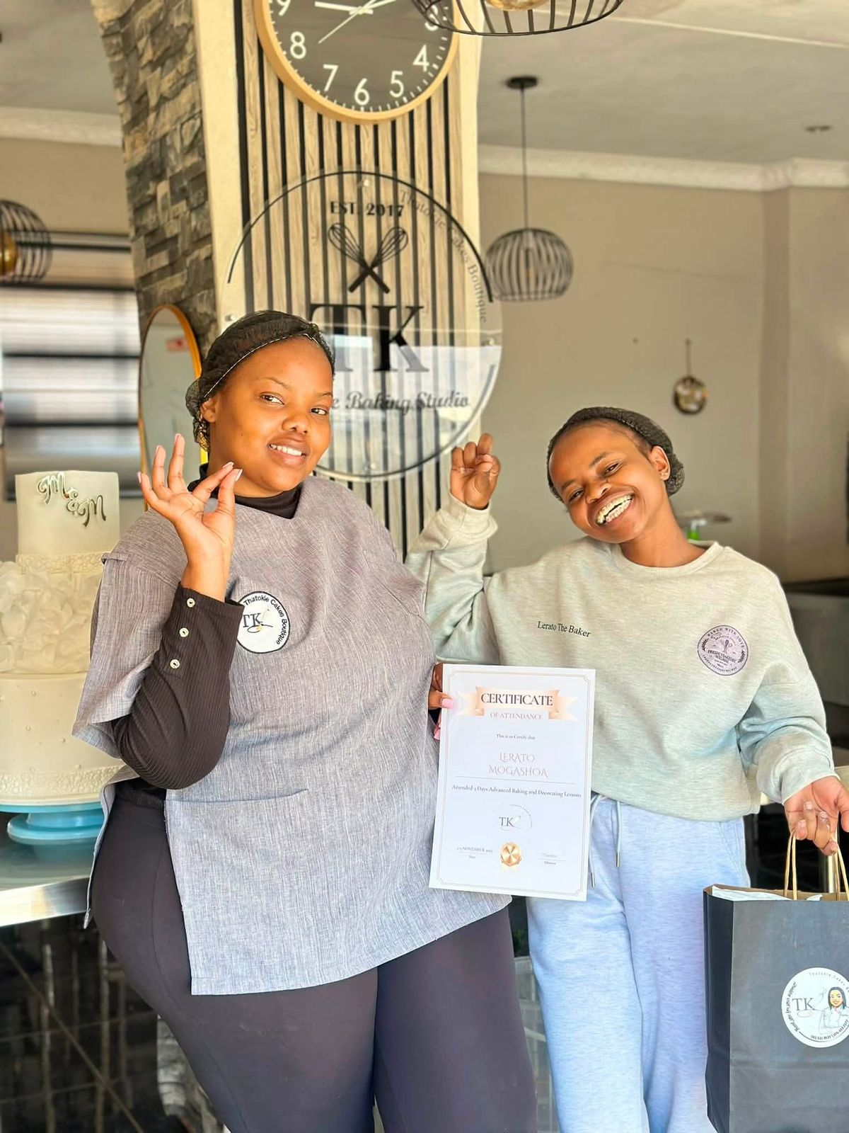 Lerato and her instructor holding the certificate of attendance